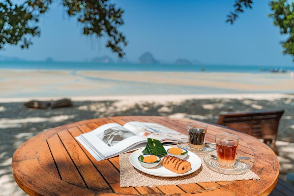 a table with plates of food and drinks on it at Krabi Home Resort in Tab Kaek Beach