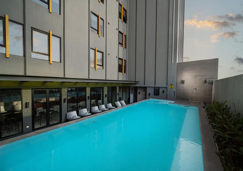 a large swimming pool in front of a building at Travelodge Georgetown, Penang in George Town