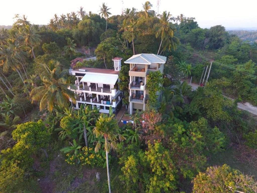 an aerial view of a house on a hill with trees at Lara's place in Unawatuna