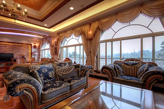 a large living room with couches and windows at Aurora in Wujie