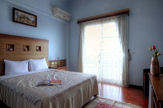 a bedroom with a large bed with a window at Aurora in Wujie