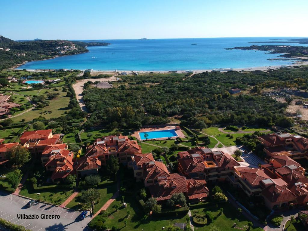 an aerial view of a house with a pool and the ocean at Sardegna Beach Ginepro in Olbia