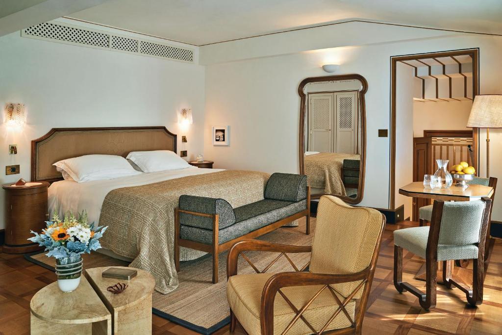 a bedroom with a bed and a living room at Splendido Mare, A Belmond Hotel, Portofino in Portofino