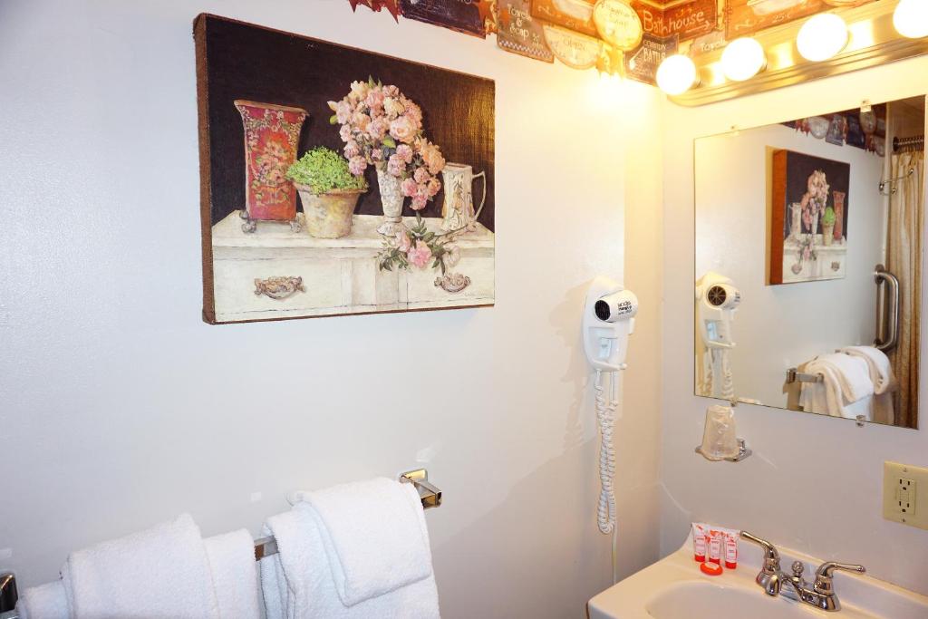 a bathroom with a hair dryer on the wall at Stay Berkshires in Williamstown