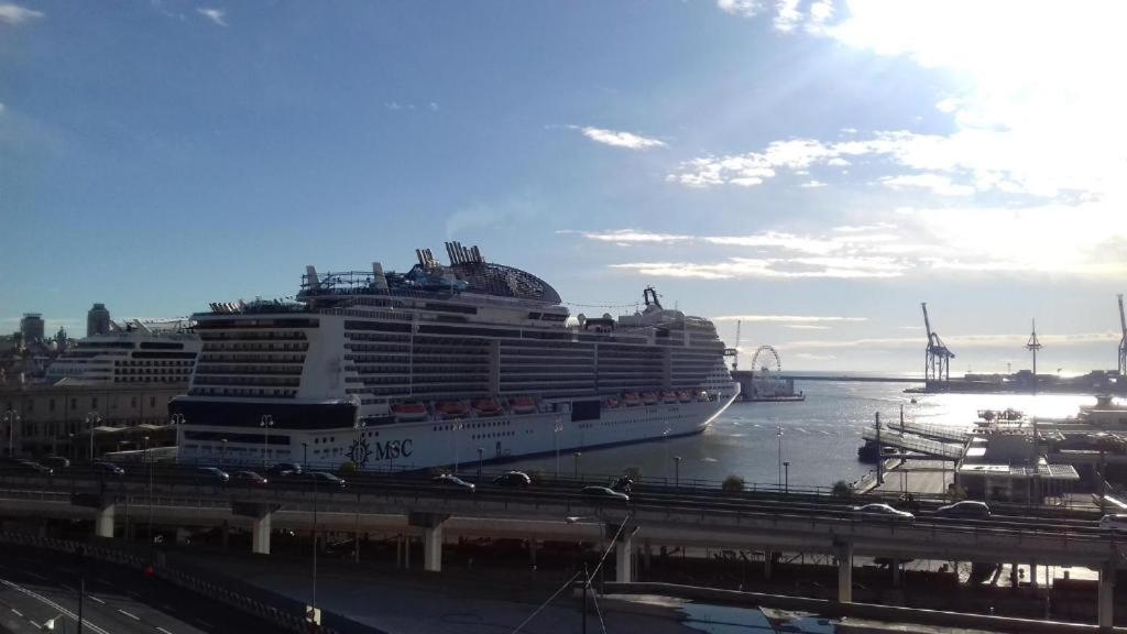 a cruise ship is docked in a harbor at Delfino Blue in Genova