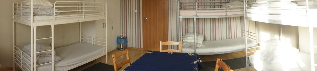 a room with two bunk beds and a blue couch at Noclegi u Matyldy in Marklowice
