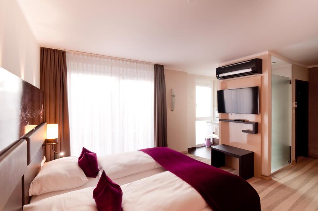 Postel nebo postele na pokoji v ubytování Amalienburg - Boutique & Boarding Hotel