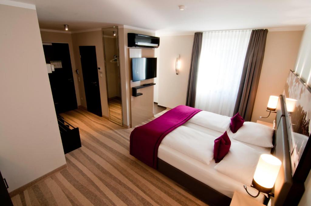 Postel nebo postele na pokoji v ubytování Amalienburg - Boutique & Boarding Hotel
