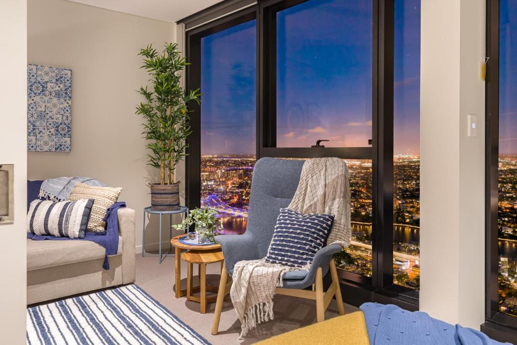 a living room with a view of a city at Hamptons Retreat on Level 77 Skytower in Brisbane