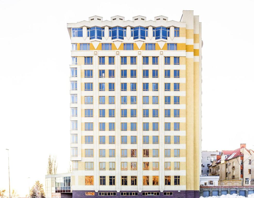 a large white building with blue windows at ERA Hotel in Saratov