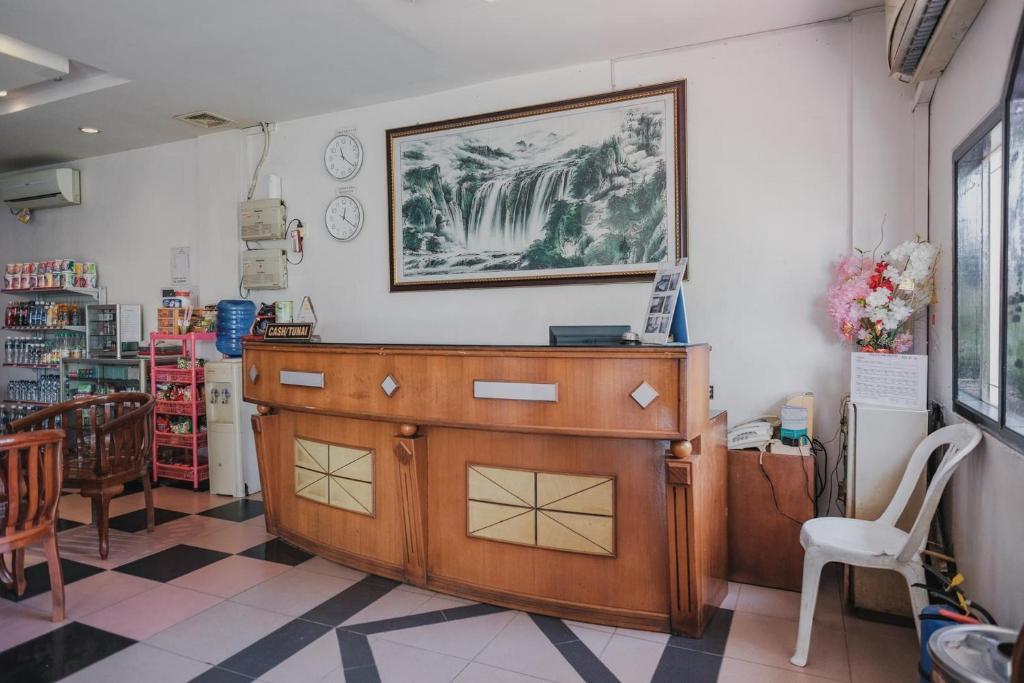 a wooden dresser in a room with a picture on the wall at Reddoorz near Nagoya Hill Mall Batam 5 in Batam Center