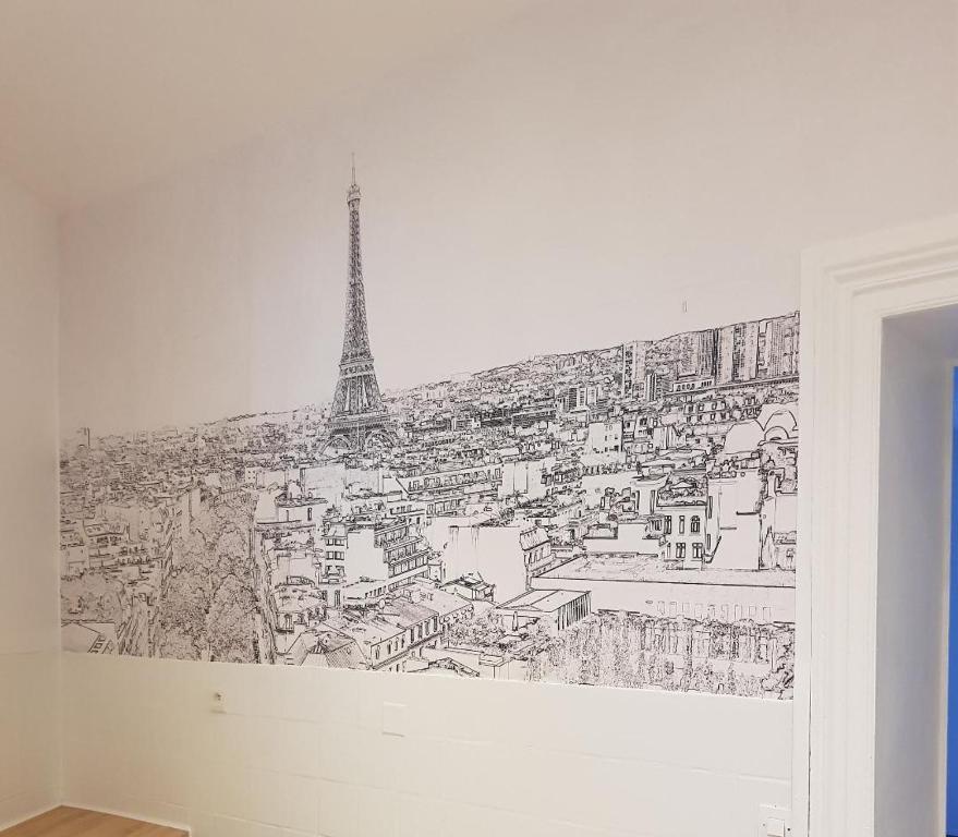 a drawing of the eiffel tower on a wall at Cosy home near Paris in Gagny