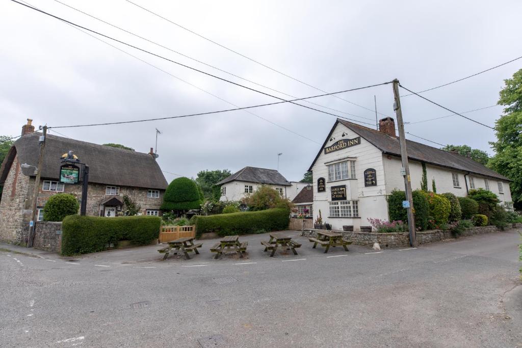 a pub with picnic tables in front of a building at The Barford Inn in Salisbury