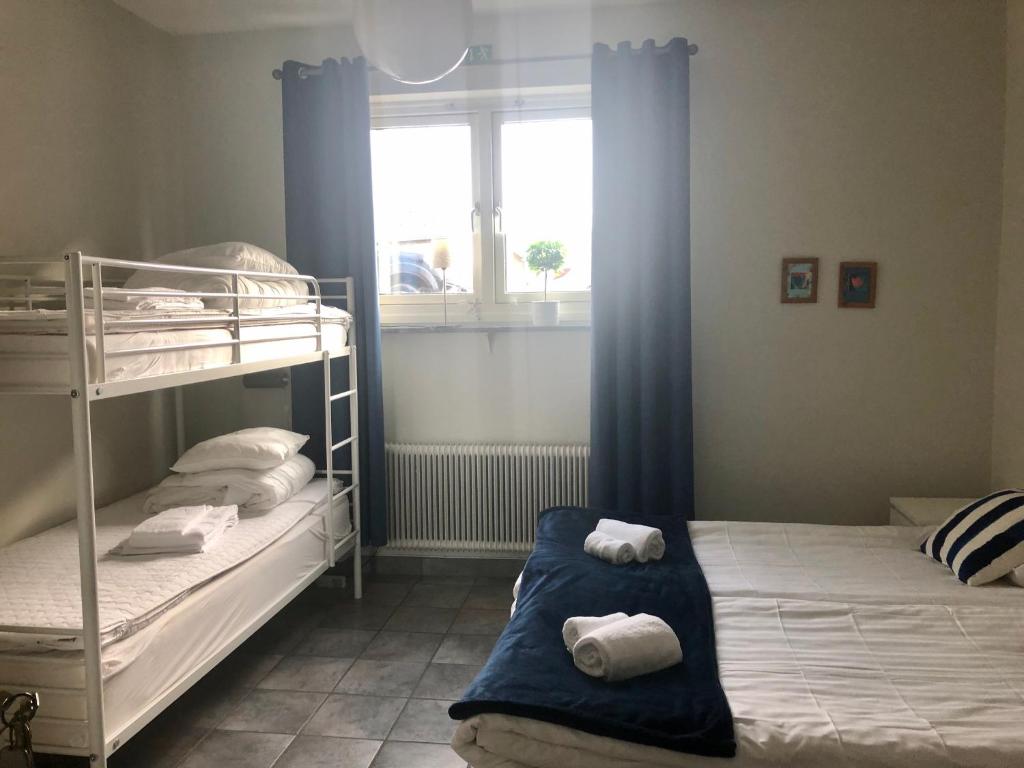 two bunk beds in a room with a window at Aurora Bed & Breakfast in Simrishamn