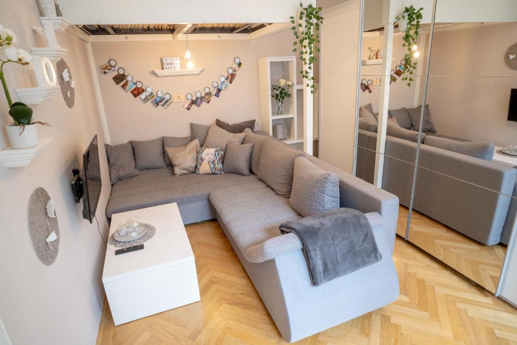 a living room with a couch and a table at Cozy Modern Nest in the Heart of Vienna with Netflix in Vienna