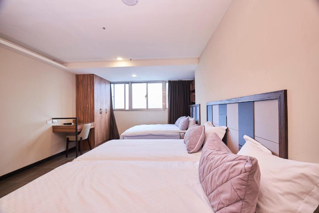 Postel nebo postele na pokoji v ubytování Greeninn Hotel