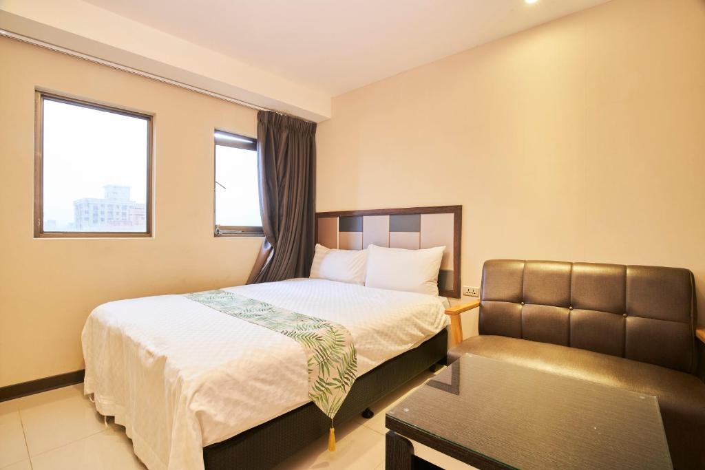 Postel nebo postele na pokoji v ubytování Greeninn Hotel