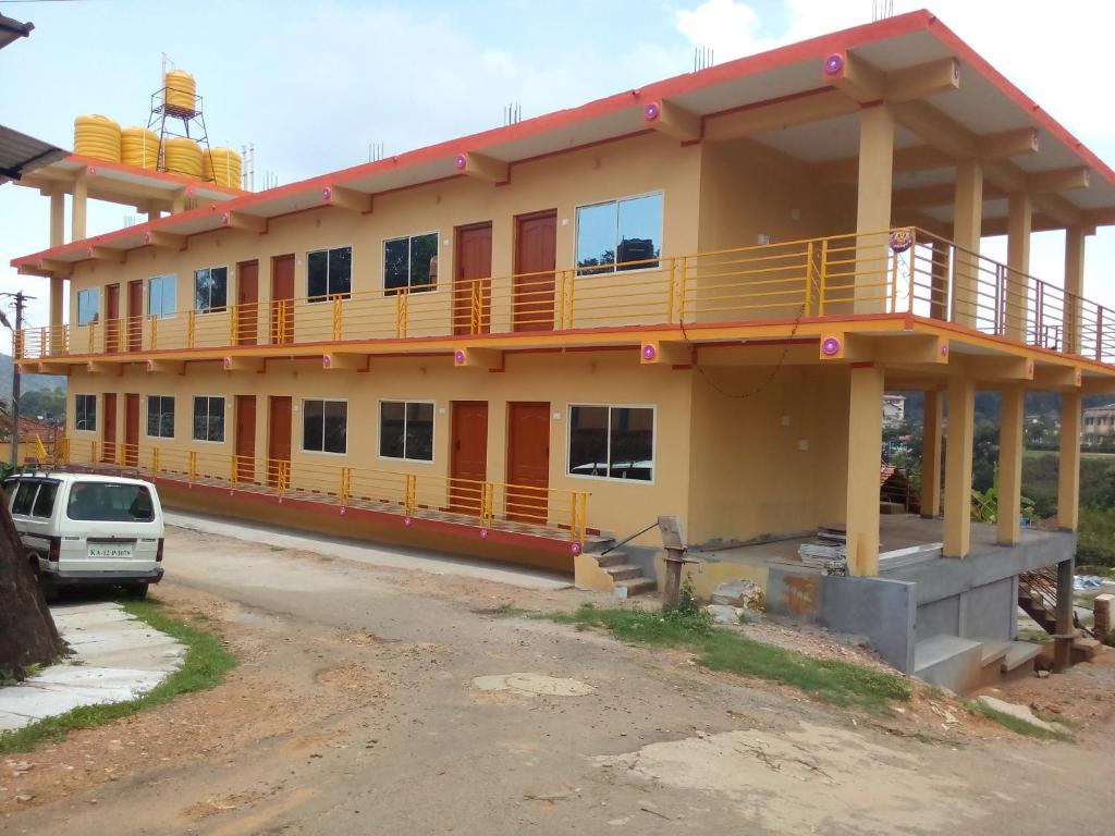 a building with a balcony on top of it at Royal Coorg Guest house in Madikeri