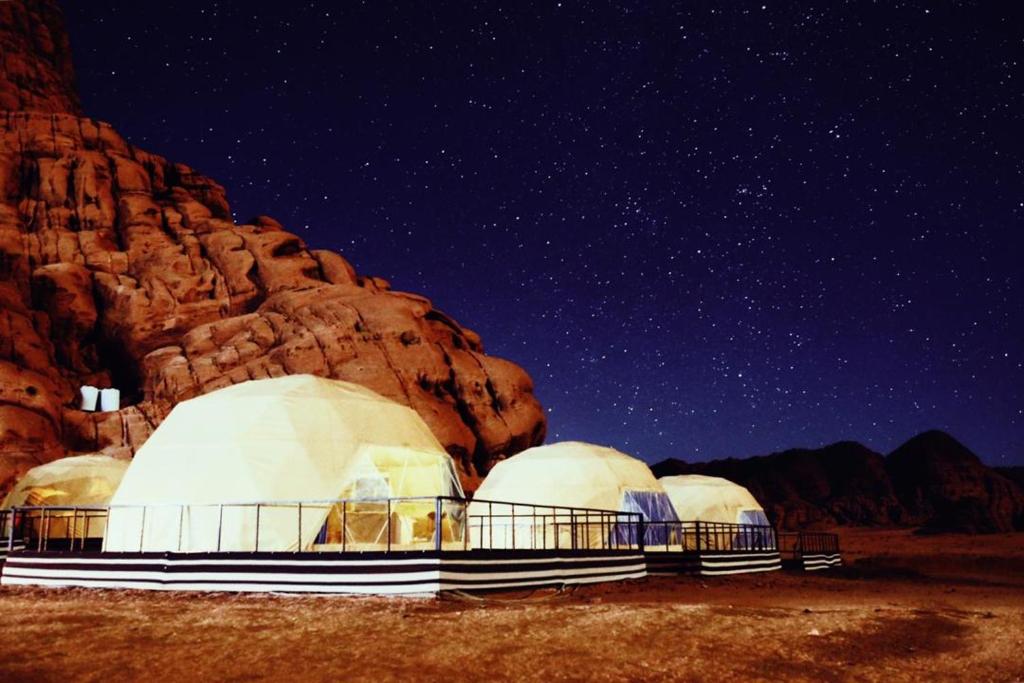 a group of domes in a desert under a night sky at Jamal Rum Camp in Wadi Rum