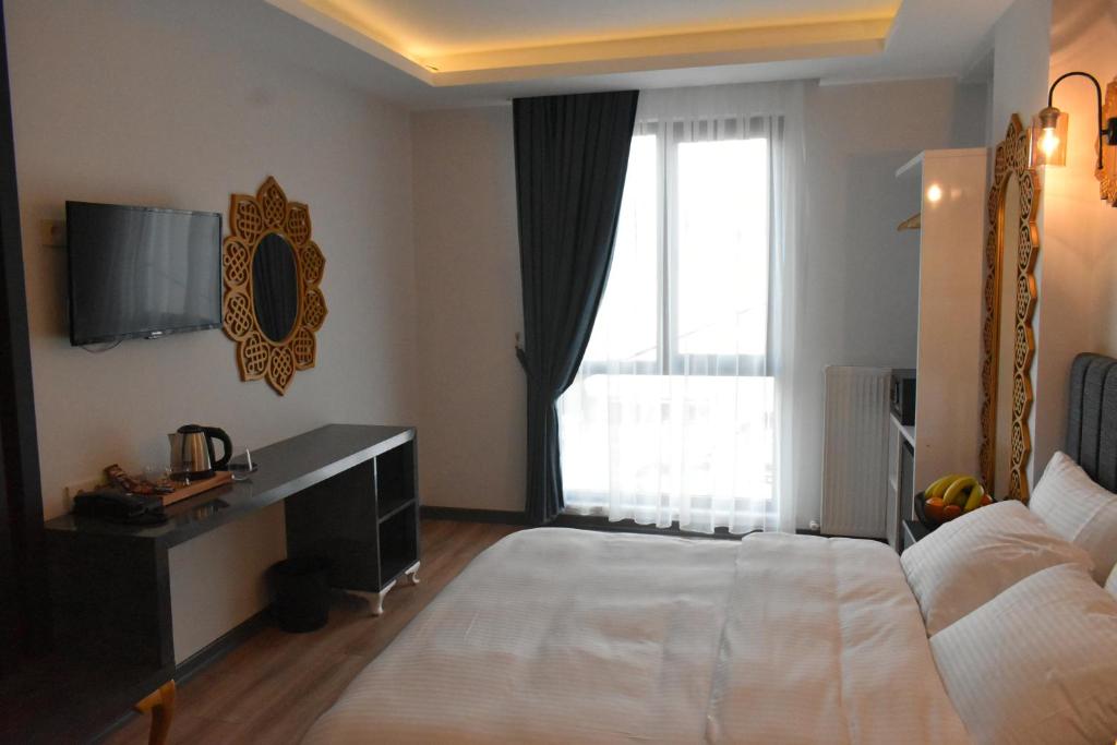 Postel nebo postele na pokoji v ubytování Avcılar Garden Hotel