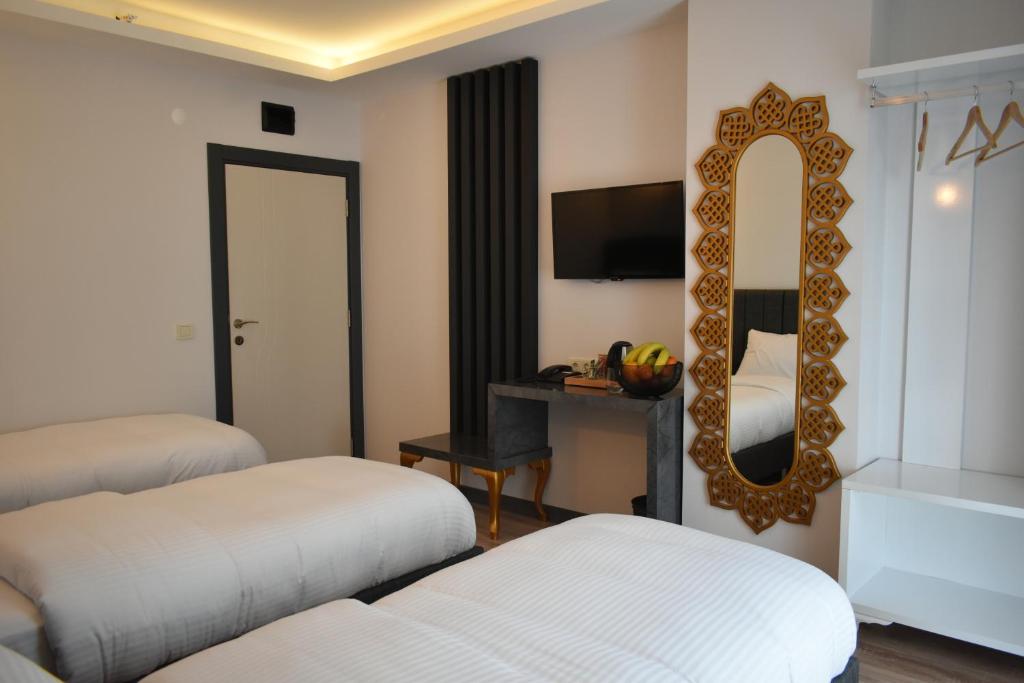 Postel nebo postele na pokoji v ubytování Avcılar Garden Hotel