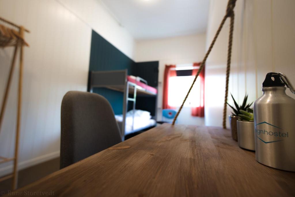 a table with a water bottle sitting on top of it at Sognhostel in Sørbø