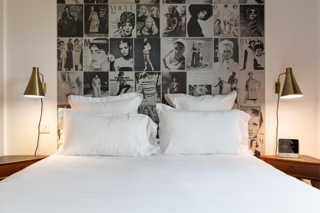 a bedroom with a large bed with white pillows at Hôtel 96 in Marseille