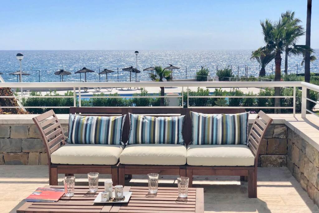 a couch sitting on a patio overlooking the ocean at B3 Casares del Mar in Casares