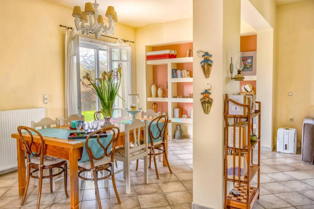 a kitchen and dining room with a table and chairs at The Cottage House in Zakynthos Town