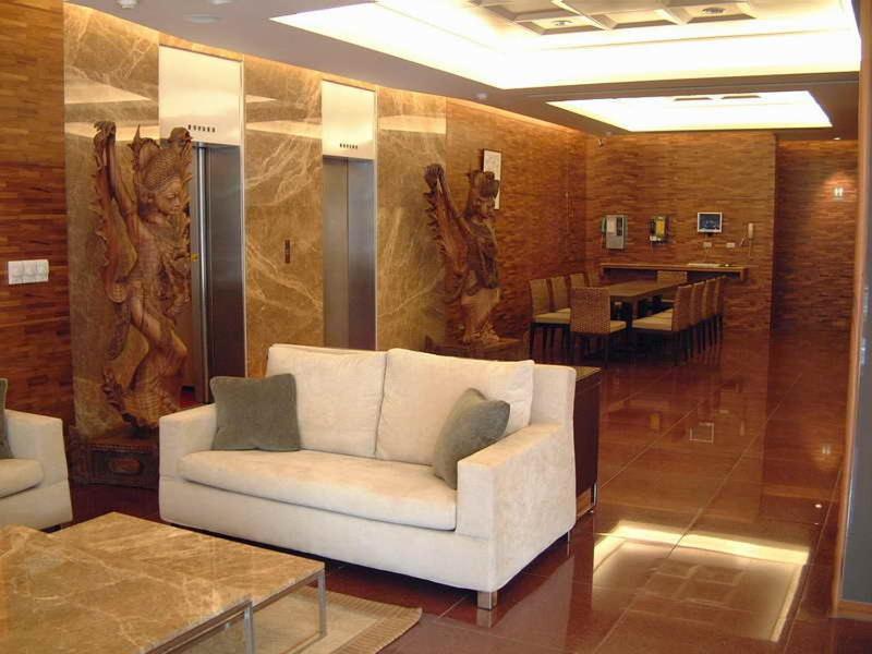 a living room with a white couch and a table at The Premier Hotel in Tainan