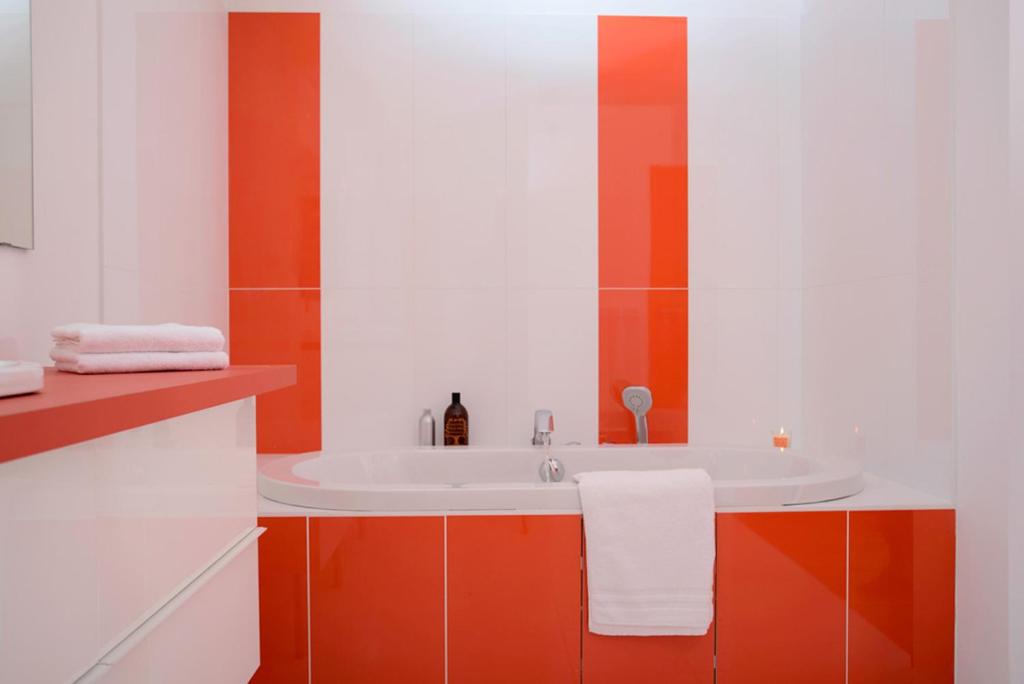 a bathroom with a white sink and orange cabinets at Hôtel 96 in Marseille