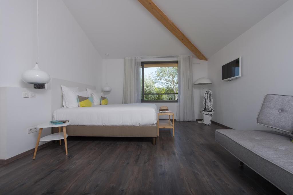 a bedroom with a bed and a window and a couch at Hôtel 96 in Marseille
