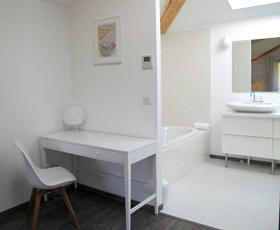 a white bathroom with a desk and a sink at Hôtel 96 in Marseille