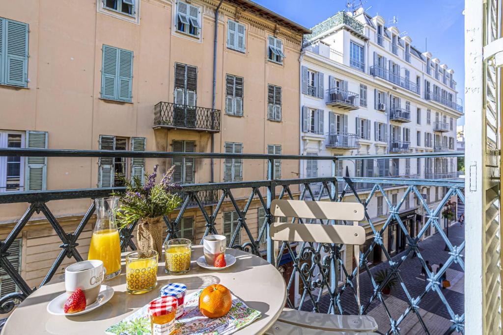 einen Tisch mit Speisen und Getränken auf dem Balkon in der Unterkunft MY CASA - Le Paradis in Nizza