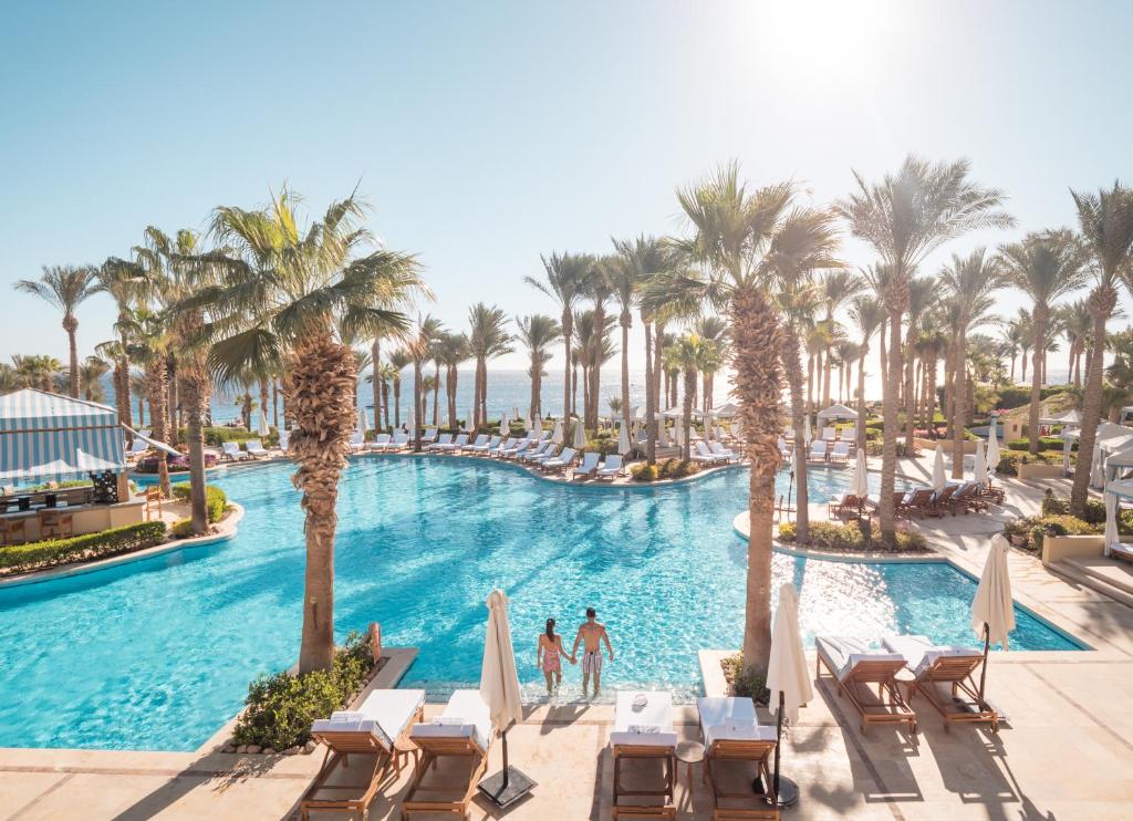 a pool at a resort with palm trees at Four Seasons Resort Sharm El Sheikh in Sharm El Sheikh