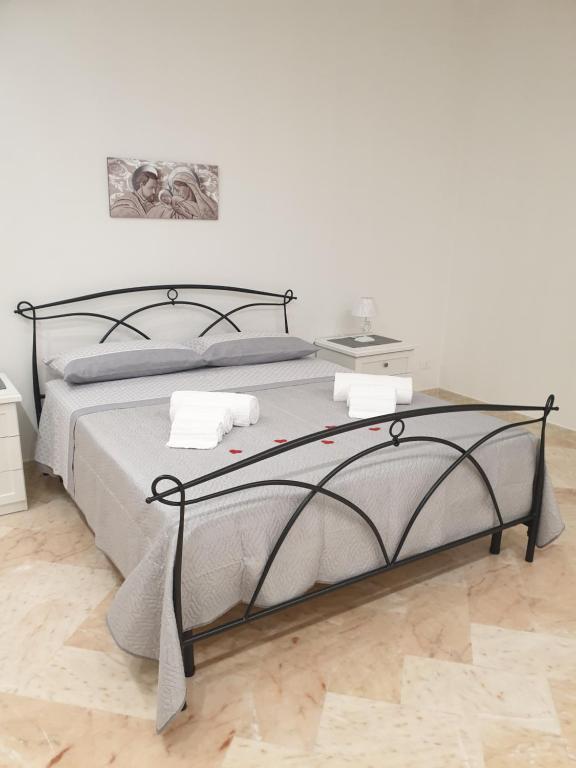 Schlafzimmer mit einem Bett mit Metallrahmen in der Unterkunft Casa del Sole - Avola in Avola