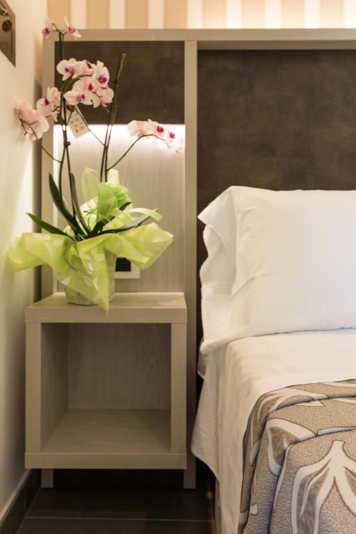 Postel nebo postele na pokoji v ubytování Hotel Cavour