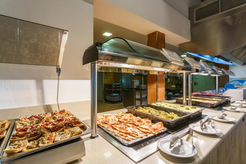 a buffet line with many different types of food at Minura Cala Galdana & Apartamentos d'Aljandar in Cala Galdana