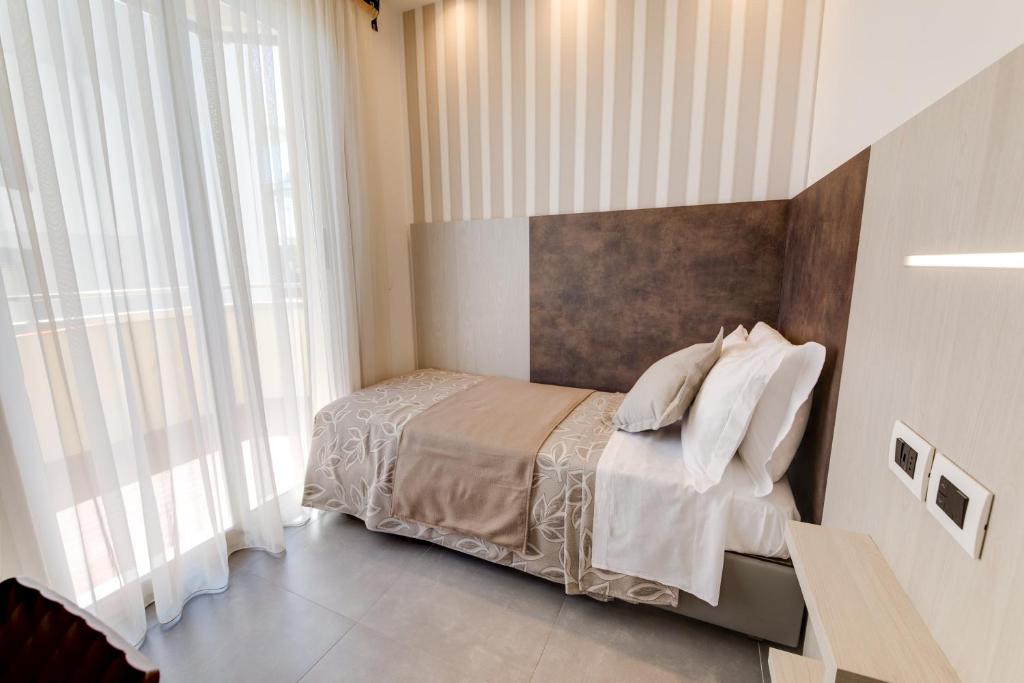 Postel nebo postele na pokoji v ubytování Hotel Cavour