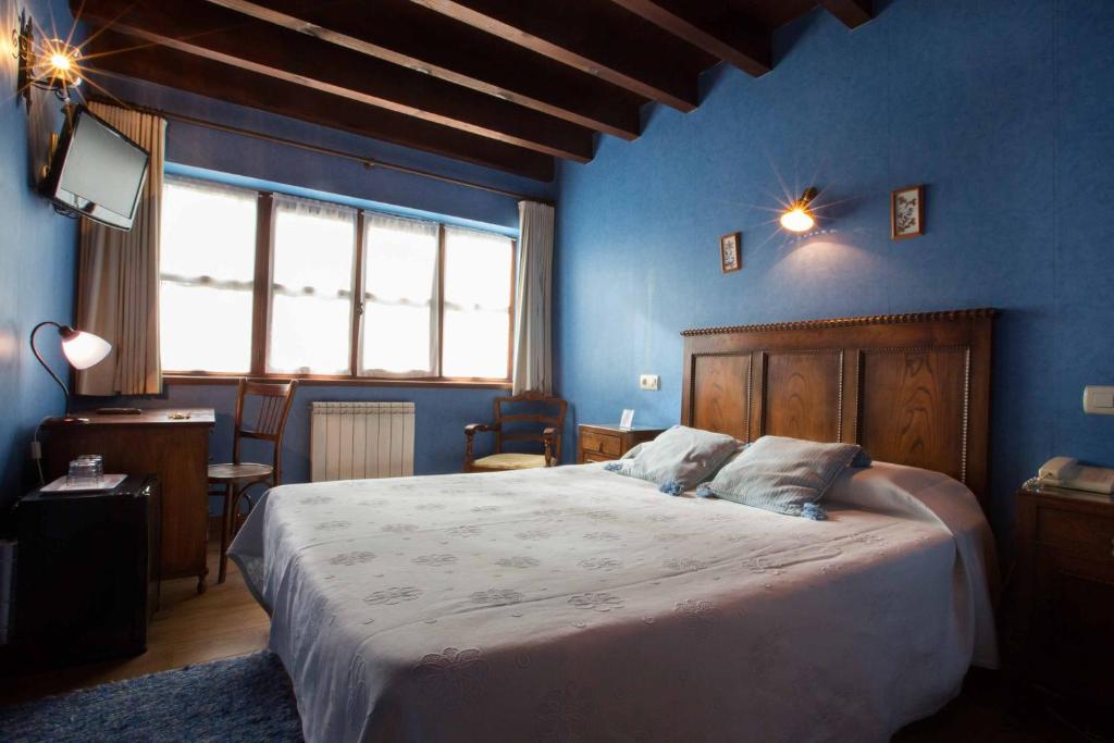 Postel nebo postele na pokoji v ubytování Hotel El Carmen