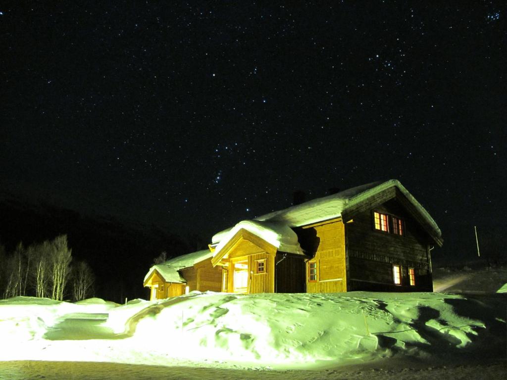 a house covered in snow at night at Hemsedal Høyfjellssenter in Hemsedal