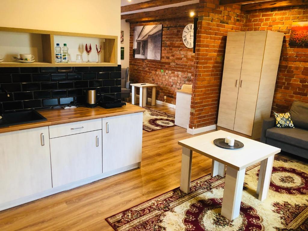 a kitchen and a living room with a table at Willa Sudecka in Racibórz