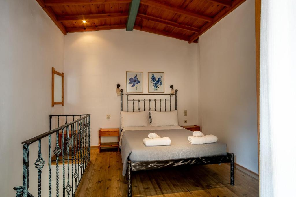 a bedroom with a bed with two towels on it at Barax Apartments in Agios Georgios