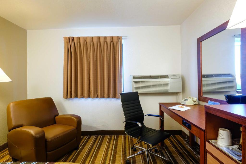 a room with a desk and a chair and a desk and a computer at Super 8 by Wyndham Las Cruces/White Sands Area in Las Cruces