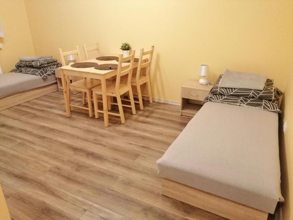 a room with a table and chairs and a dining room at Apartament Reymonta in Łowicz