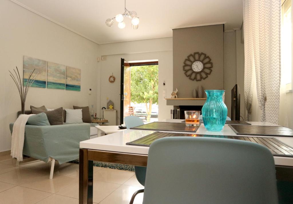 a living room with a blue vase on a table at Modern Riviera Azure Residence close to beach in Athens