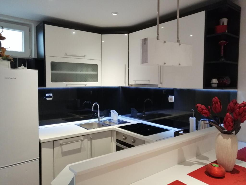 a kitchen with black and white cabinets and a sink at Gabi in Makarska