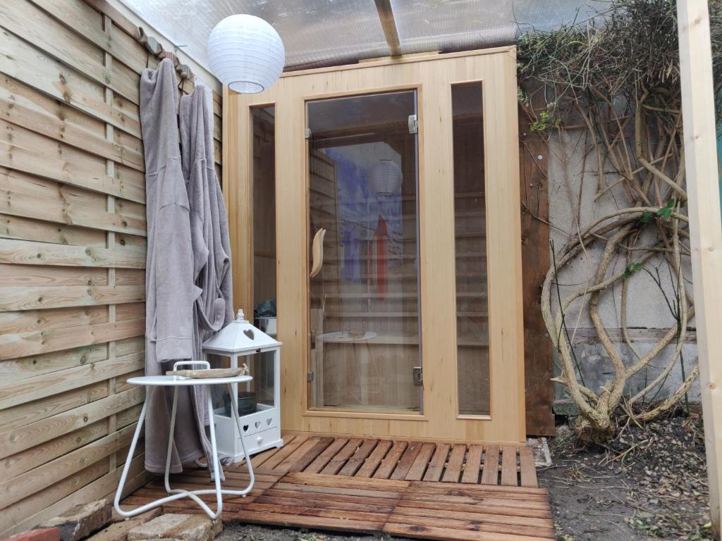 une porte coulissante en verre sur une terrasse en bois dans l'établissement Atelier 39bis, à Honfleur