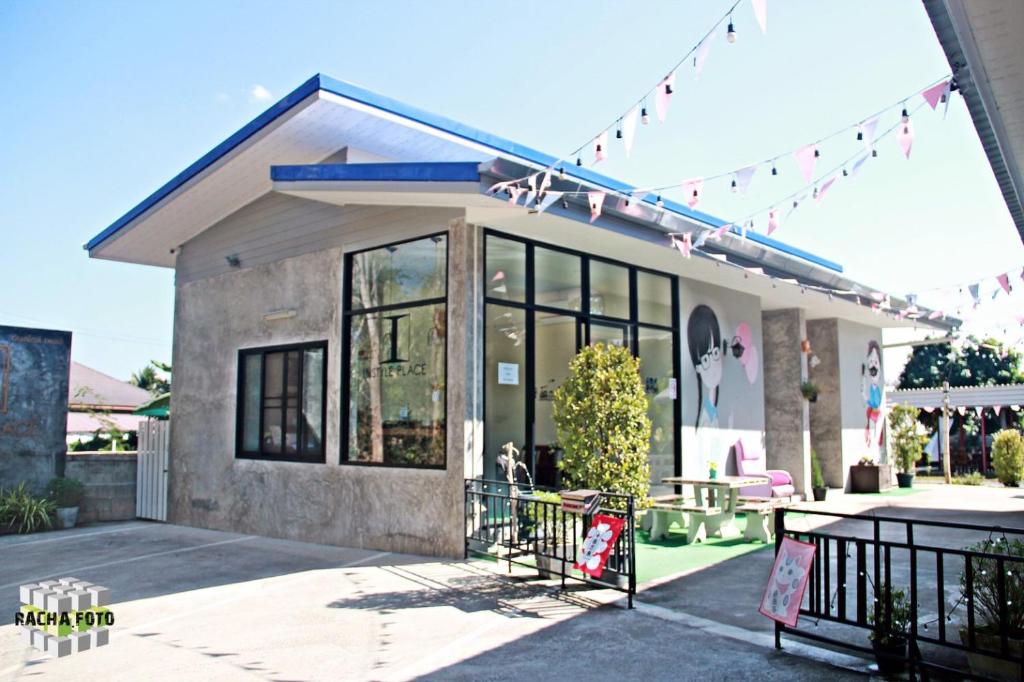 a building with a dog sitting outside of it at Instyle Place in Chiang Rai