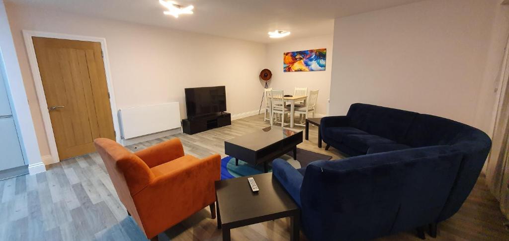 a living room with two couches and a tv at Garland Modern Spacious Apartment, Brentwood 1 in Brentwood